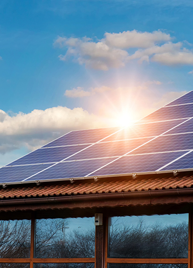 House with solar panels at sunset