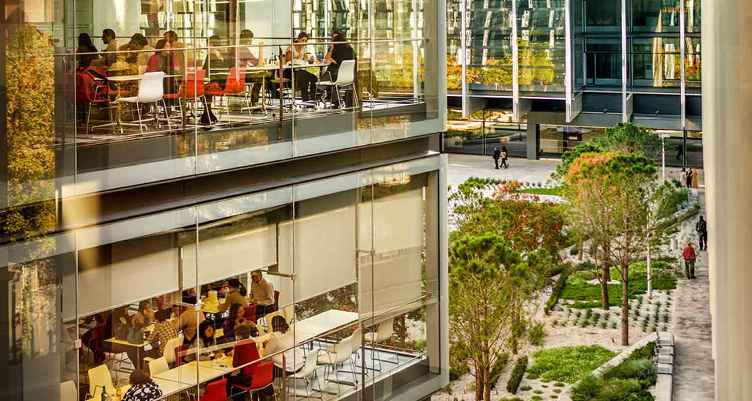 Awards and recognition. Image of a glass building surrounded by a garden area