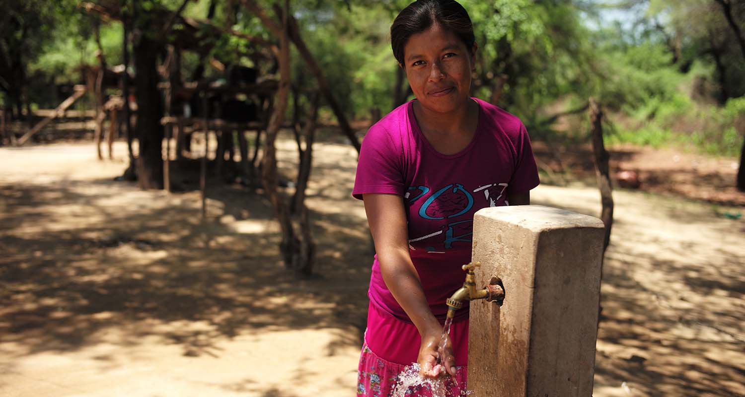 Bolivian woman at a fountain