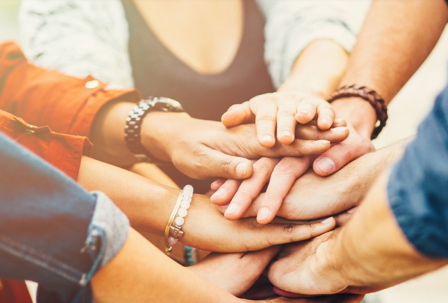 Close-up of hands stacked on to of each other